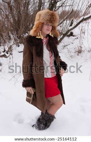 woman in sheepskin and fox cap in winter park