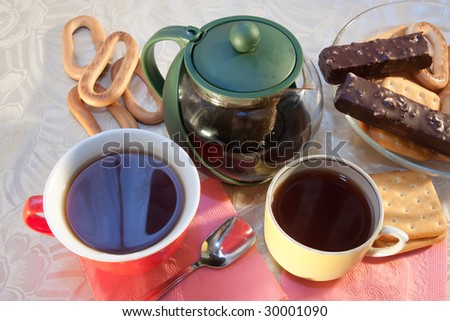 caps of tea and cookie on cook-table