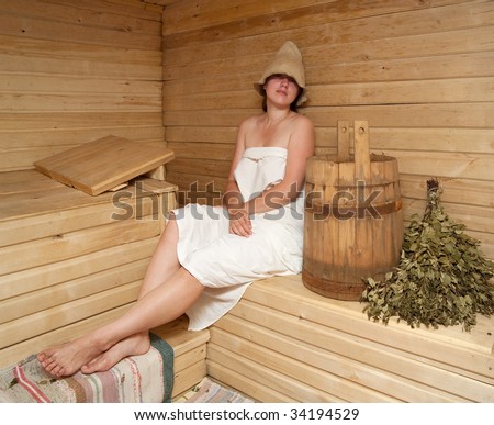 Young woman is taking a steam-bath  at sauna bath