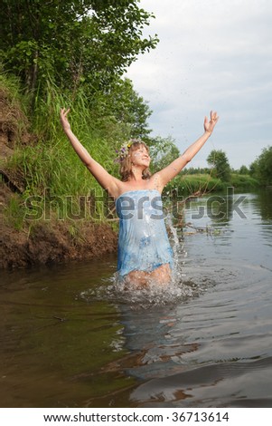 Jumping girl  in flower chaplet at river