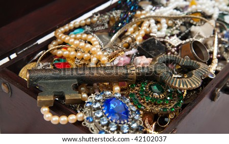 wooden treasure chest with valuables and key. Focus on key