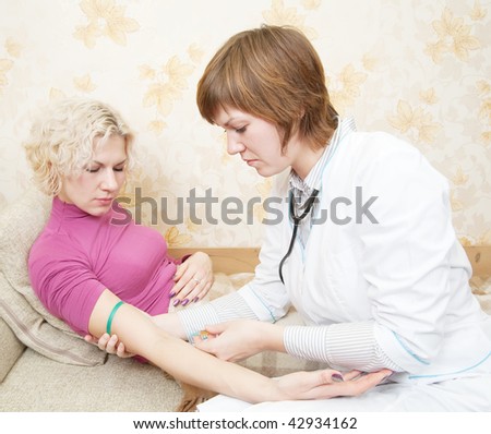 Doctor giving a girl an intravenous injection in her forearm