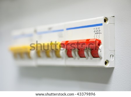 Red electrician circuit breaker on control panel