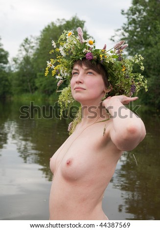 stock photo Topless girl in flowers wreath in river