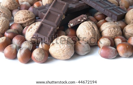 brown nuts and stick of chocolate over white
