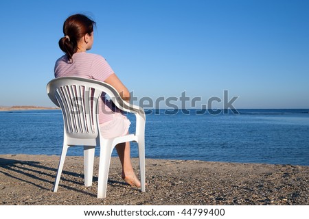 beauty woman  relaxing in deck chair at resort beach