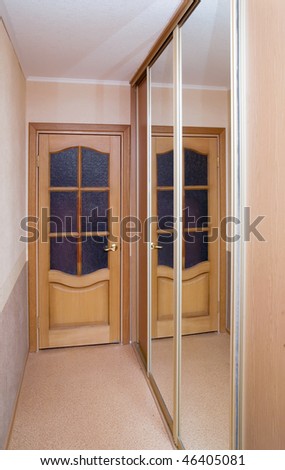 Wooden door and mirror in  modern interior