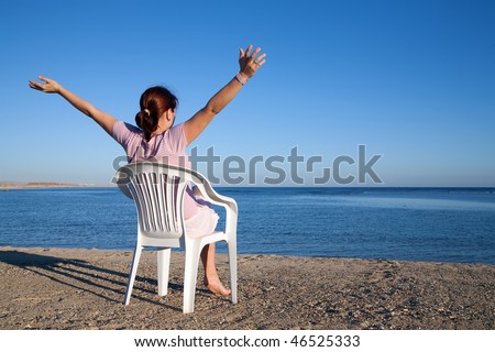 beauty girl  relaxing in deck chair at resort beach