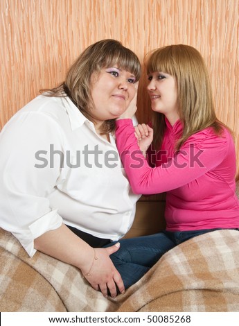 Woman whispers to the girlfriend secrets