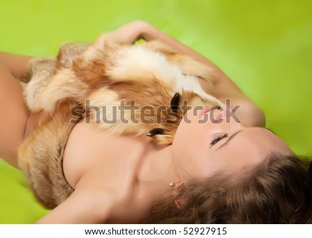 woman covered with a fox fur on green background