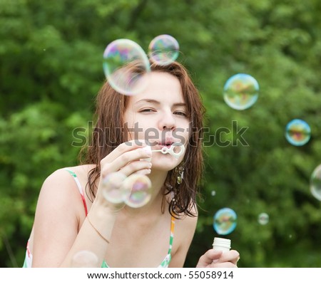 girl making soap bubbles on a summer day