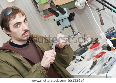 Male jeweller is working at jeweller's workshop