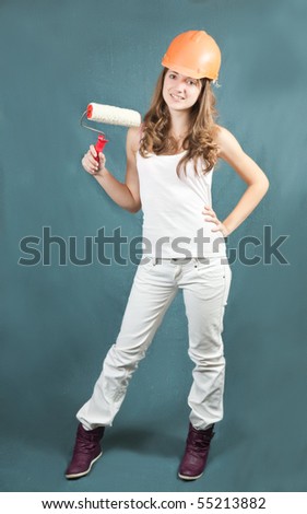 female painters with paint rollers over grey background