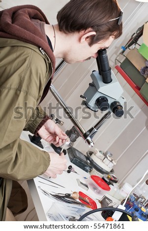 jeweller is working with  microscope at jeweller\'s workshop