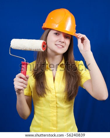 Girl with paint rollers over blue background