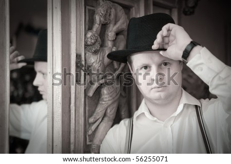 Vintage portrait of man in black fedora hat