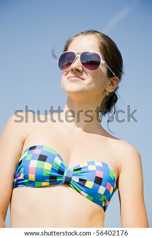 stock photo young teen girl wearing sunglasses against sky