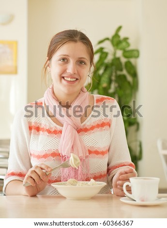 smiling girl  eating dumplings  at lunch counter