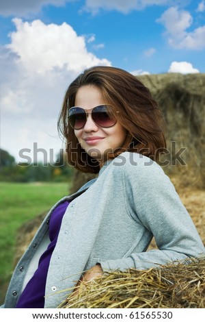 young brunette girl wearing sunglasses against sky