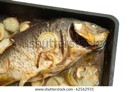 Closeup of grilled carp fish  on the cook griddle over white