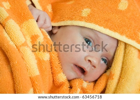 New born baby wrapped in warm blanket.