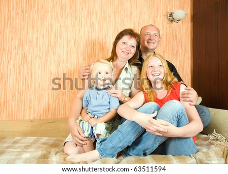 Portrait of happy family relaxing together indoor