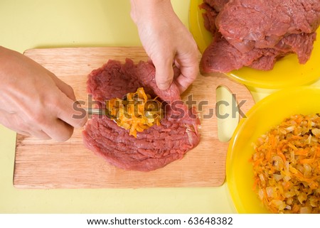 Closeup of cook making stuffed beef. One of the stages of preparation of the stuffed beef.  See series