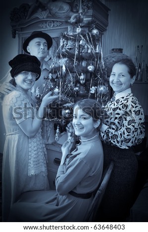 Retro photo of Family near Christmas tree at home