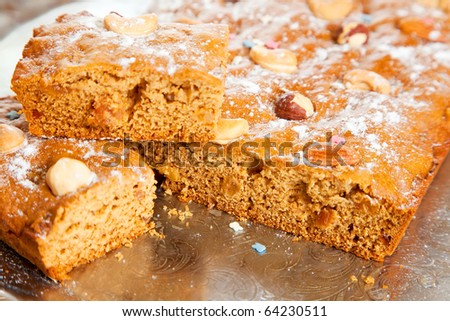 homemade fresh  honey cake with nuts on tray. The end of cooking of  honey cake.  See series