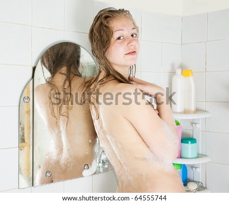 Rear view of long-haired girl in bath