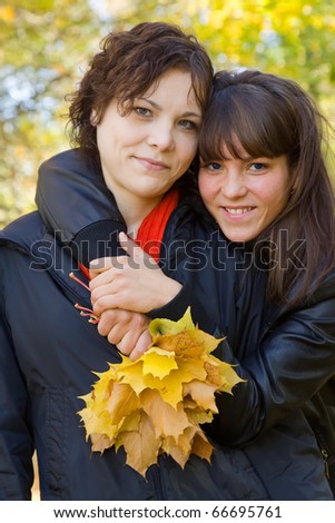 Portrait of two pretty girls  in autumn park