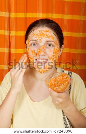 woman making bio cosmetic pack from carrot, oatmeal and egg yolk