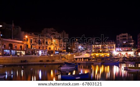 Boats at quay in St. Julian\'s bay in night. Malta