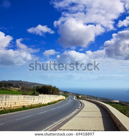 asphalt road through mediterranean cliffs. Maltese islands