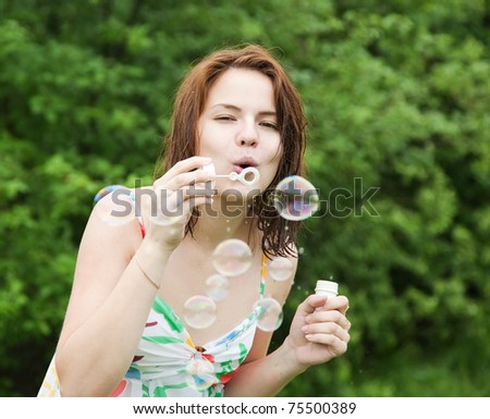 girl making soap bubbles on a summer day