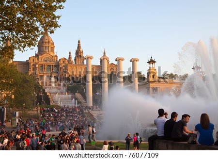 BARCELONA, SPAIN - APRIL 9: People looking and listing  Magic fountain in April 9, 2011 in Barcelona, Spain.  Magic fountain at Barcelona - first and famous in world