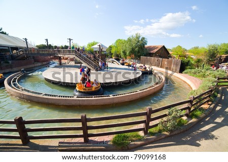 SALOU, SPAIN - APRIL 11: People riding in Theme Park in April 11, 2011 in Salou, Spain.  Grand Canyon Rapids  is one of most exhilarating rides in Old American West area at Port Aventura
