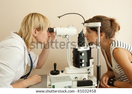 oculist and patient testing  eyesight  in clinic