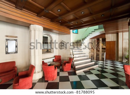 Hall in hotel with red   armchair and stairs
