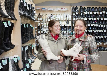 Two women shopping at fashion shoes shop