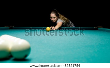 Casual dressed woman plays russian billiards
