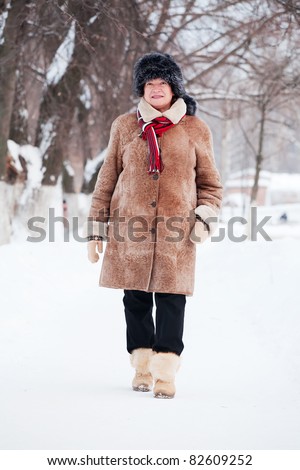Portrait of mature woman in coat and fur cap