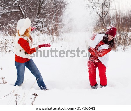 Two  girls plays with snow at winter park