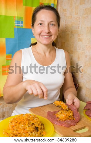 Woman making stuffed beef in her kitchen. One of the stages of preparation of the stuffed beef.  See series