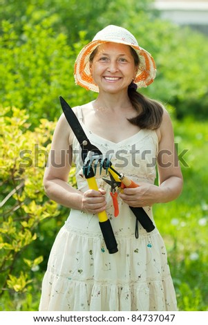 Happy mature woman gardening in yard