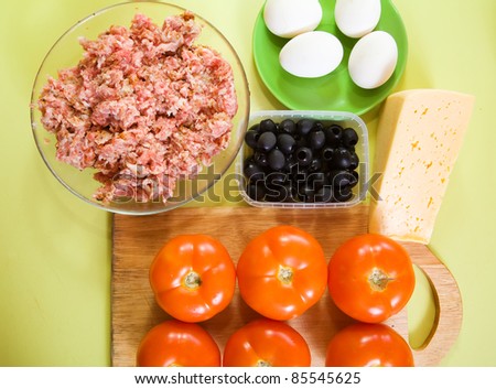 ingredients for stuffed tomato on cook-table. See in series stages of cooking of stuffed tomato