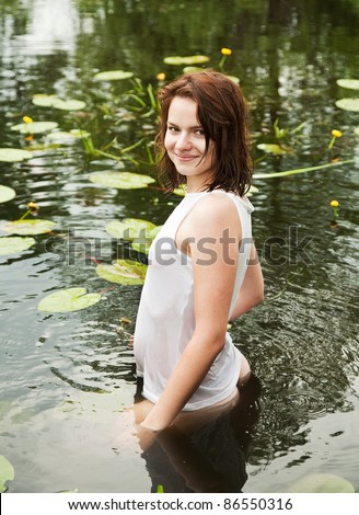 stock photo Sexy girl in white wet shirt at lake