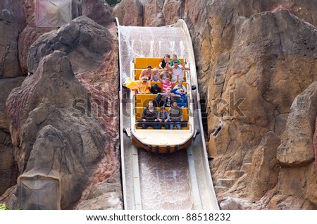 SALOU, SPAIN - APRIL 13: People ride in Theme Park in April 13, 2011 in Salou, Spain.  Tutuki Splash is one of most exhilarating rides in Polynesia area at Port Aventura