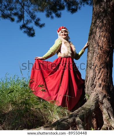 girl is in european historical clothing  of XIII century at nature
