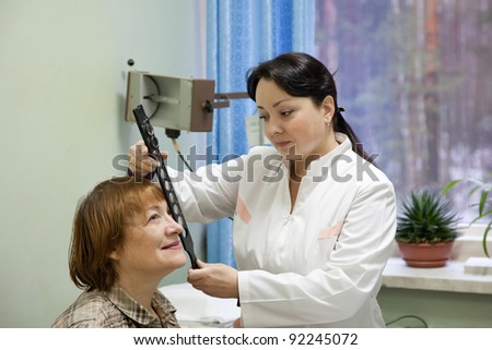 ophthalmologist  and patient testing  eyesight  in clinic